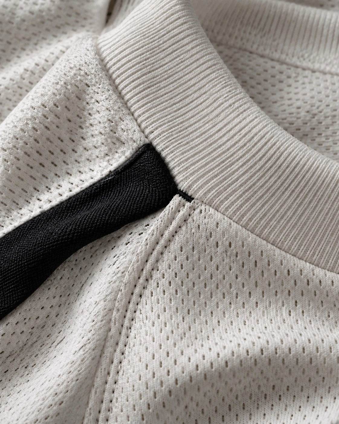 Illustrative close view of knit openings and textile surface for comparing running-shirt fabric questions