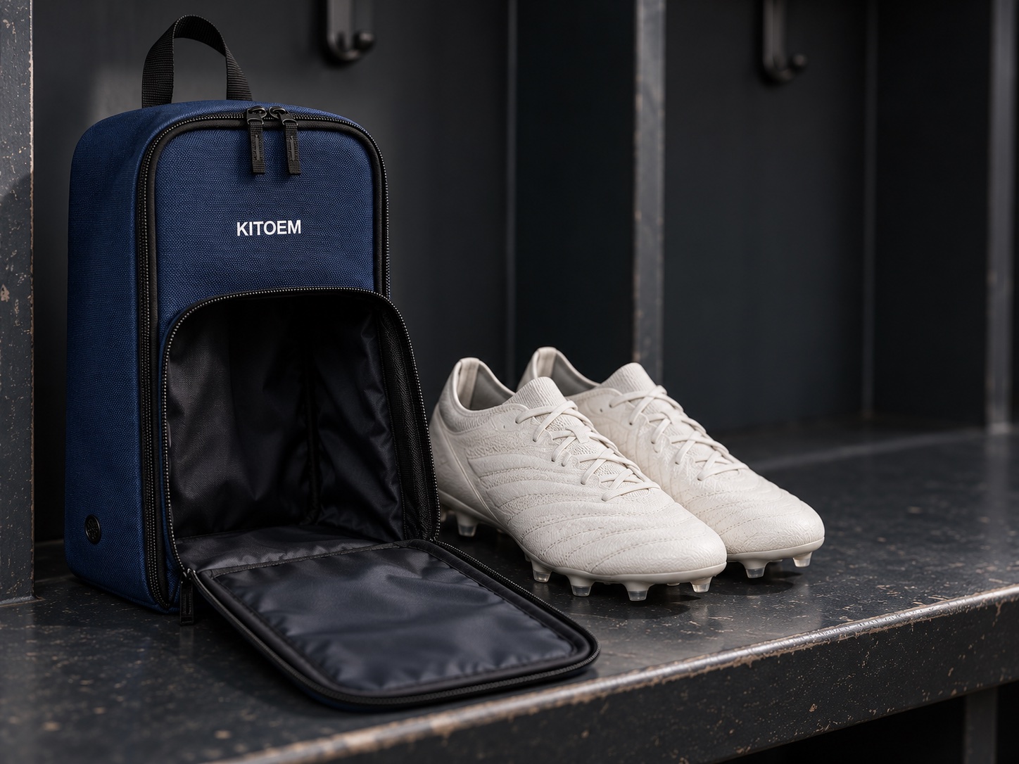 Navy KITOEM boot bag showing a clean front identity area, carry loop and double zipper
